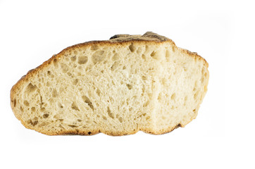 Cut piece of white grain artisan backed bread loaf close up isolated on pure white