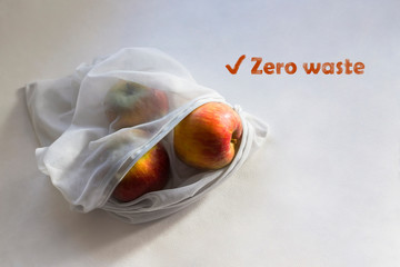 Apples in reusable fruit pouch in the sunlight with shadows