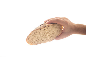 Cut piece of white grain artisan backed bread loaf held by Caucasian male hand close up isolated on pure white