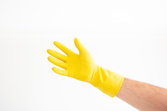 White Caucasian male hand with yellow latex glove open palm against white background