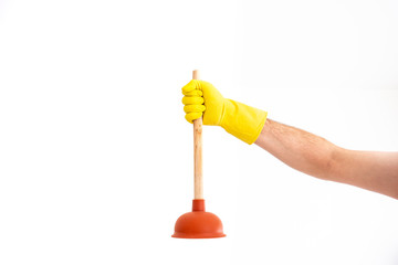 White Caucasian male hand with yellow latex glove holding a sink plunger against white background