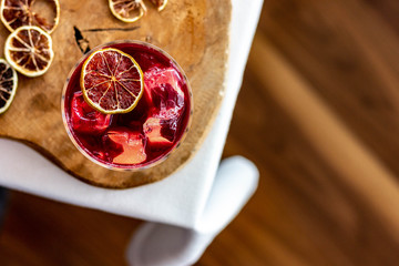 Vine cocktail with dried lemon on an elegant table. 