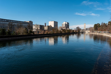 Zurich city view of the Limmat river and industrial building in the background sunny day Switzerland.