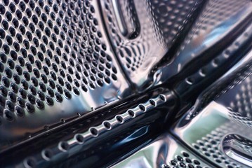 Washing machine tank or drum, background, texture. Perforated steel drum of washing machine. Inside...