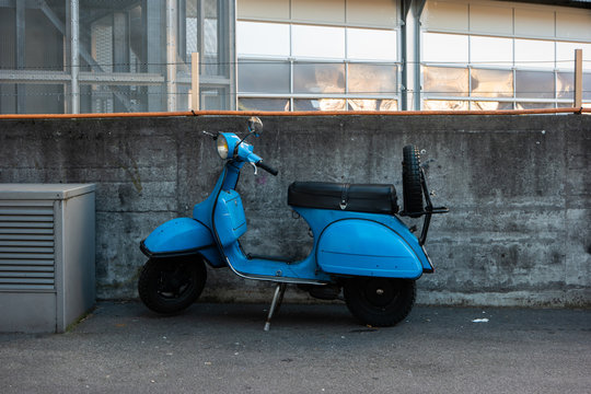 Vintage blue gas powered city scooter moped parked on the streets of Zurich Switzerland