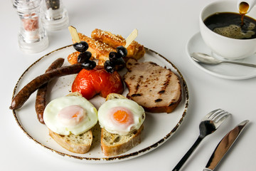  Gourmet breakfast with fried eggs and coffee on a white table of a brakfast place