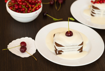 Sweet dessert. Chocolate cookies with a sweet vanilla sauce and fresh cherries