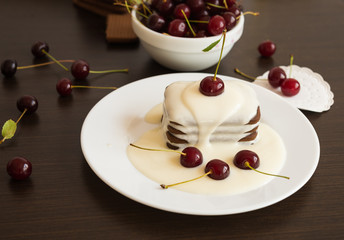 Sweet dessert. Chocolate cookies with a sweet vanilla sauce and fresh cherries