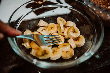 Process of mixing healthy and natural ingredients to cook at home some oatmeal, chocolate and banana cookies without refined sugar. Real food. Lifestyle