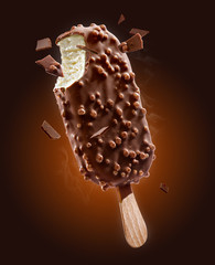 ice cream with chocolate glaze on dark brown background