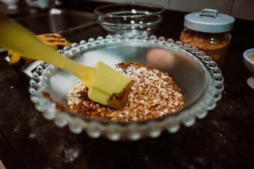 Process of mixing healthy and natural ingredients to cook at home some oatmeal, chocolate and banana cookies without refined sugar. Real food. Lifestyle
