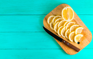 .cut lemon and knife on a blue background