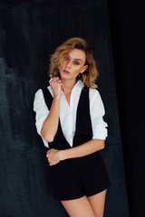 Fototapeta premium Portrait of a beautiful fashionable stylish woman in clothes poses