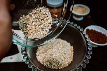 Process of mixing healthy and natural ingredients to prepare at home some oatmeal, chocolate and banana cookies without refined sugar. Real food. Lifestyle
