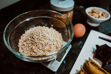Selection of healthy and natural ingredients to prepare at home some oatmeal, chocolate and banana cookies without refined sugar. Real food. Lifestyle