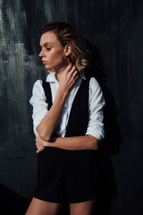 Fototapeta premium Portrait of a beautiful fashionable stylish woman in clothes poses