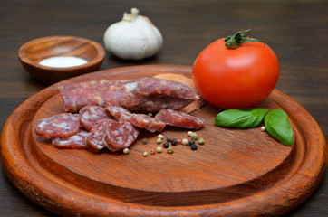 sausage and vegetables on a wooden board 