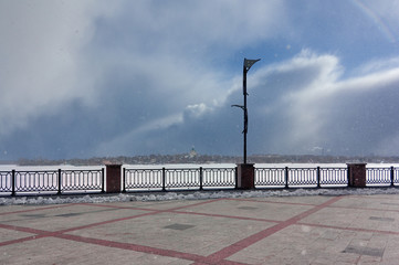 View of the frozen city pond from the waterfront. Nizhny Tagil Sverdlovsk Region Russia. View of Nizhny Tagil from the pond.