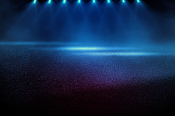 Dark street, wet asphalt, reflections of rays in the water. Abstract dark blue background, smoke, smog. Empty dark scene, neon light, spotlights. Concrete floor