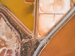 Aerial picture of Trapani salt evaporation pondsand salt crystals are harvested as water dries up sometimes these ponds have vivid colours, Sea salt farm or salt evaporation plant.
