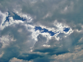 The Rays of the Sun Make Their Way Through the Dark Cumulus Clouds Forming a Grandiose Relief Picture