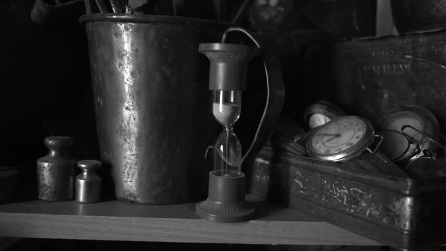 hourglass. time does not stop, the old shelf of objects