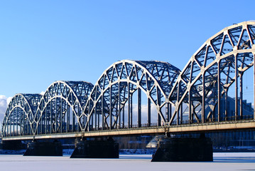 Fototapeta premium Riga city railway bridge against the blue sky