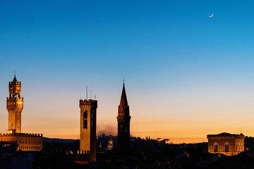 Naklejka premium Rooftop panorama of Florence at sunset during blue hour with Palazzo Vecchio town hall, Chiesa Orsanmichele church and the Moon in the Sky