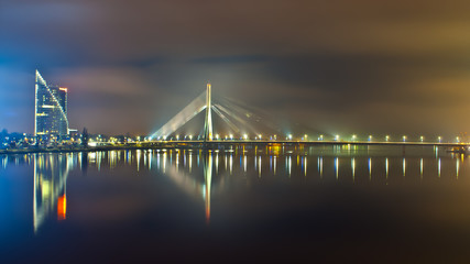 Riga, cable- stayed bridge lit by lights in the evening