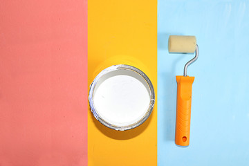 Can of paint for repair on a multi-colored painted background. Banner for the shop, geometry....