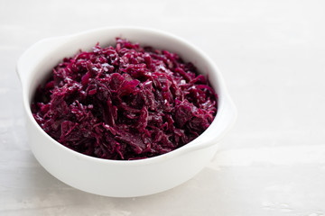 salad purple cabbage on white bowl on ceramic background