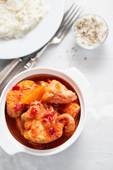 baked turkey meat in white bowl and boiled rice on white plate