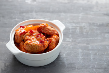 baked turkey meat in white bowl and boiled rice on white plate
