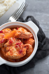 baked turkey meat in white bowl and boiled rice on white plate