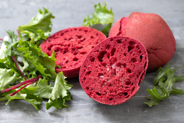 beet red bread on wooden tray and ceramic background