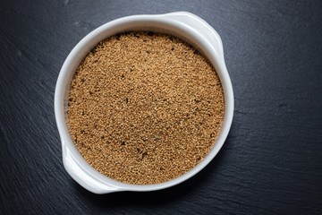 quinoa on white bowl on ceramic background