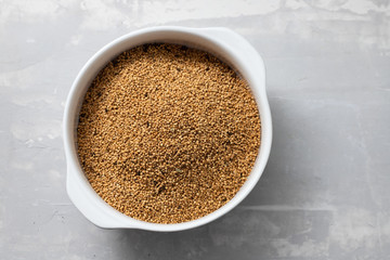 quinoa on white bowl on ceramic background