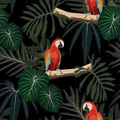 Beautiful seamless floral summer pattern with parrot, palm leaves. Perfect for wallpapers, web page backdrop, surface textures, textile. Dark night background.