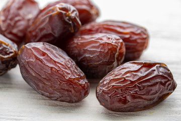 Dates big on wooden background