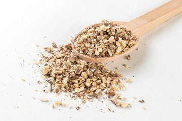 dandelion root or in latin Taraxaci radix in wooden spoon isolated on white background. medicinal healing herbs. herbal medicine. alternative medicine