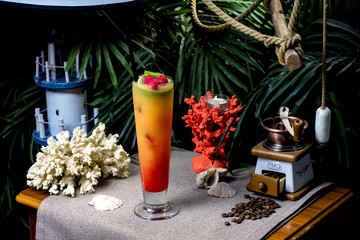 beautiful exotic cocktail with fruits on a beach background