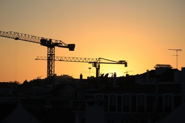 Cranes working at sunset in Lisbon