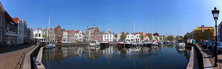 Panoramic view of the historical harbor in the old town of Goes / Netherlands with ancient house...