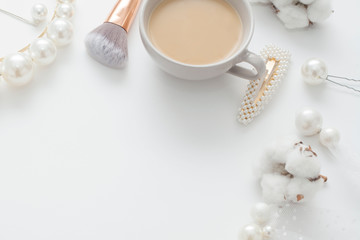 Jewelry for the bride, pearls, makeup brushes, delicate colors, candy and coffee, on a white background. Conceptual photography for weddings, preparation and morning of the bride.