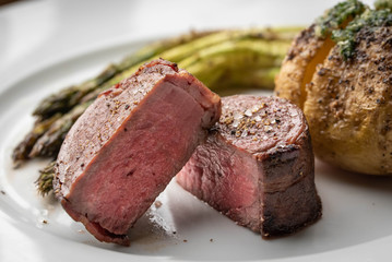 bacon wrapped tenderloin steak on white plate