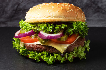 fresh tasty beef burger on dark background