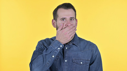 Portrait of Wondering Young Man in Shock, Yellow Background