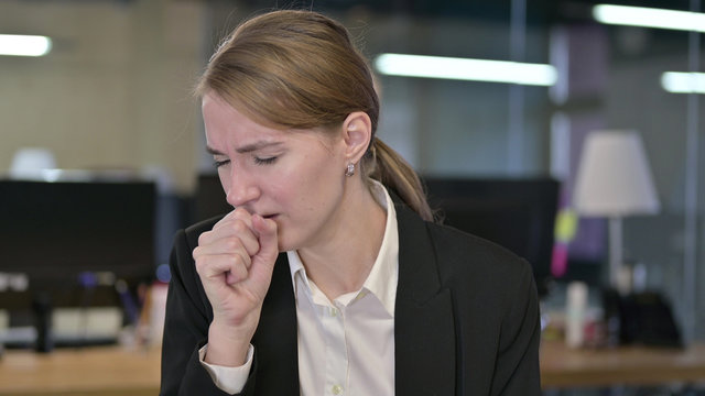 Portrait of Sick Young Businesswoman Coughing