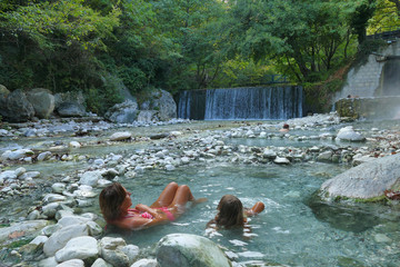 tourists relax in the warm thermal waters of Pozar in Greece