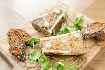 Beef bone marrow with chimichurri sauce and toasted bun. Served on a chopping wooden Board. Menu BBQ restaurant